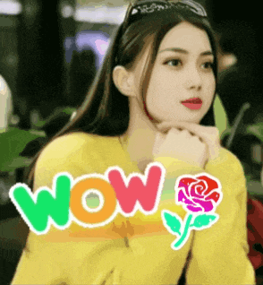 a woman wearing a yellow sweater with the word wow written on it