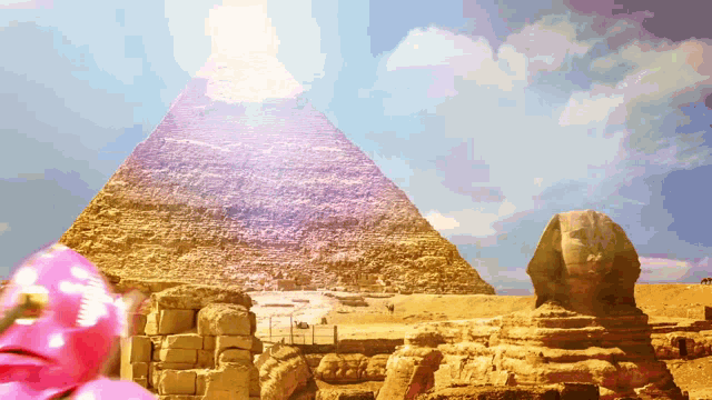 a pyramid and a sphinx are visible in the distance