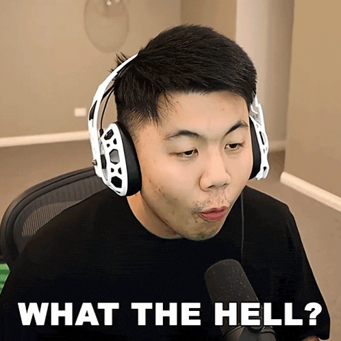 a man wearing headphones and a microphone is asking what the hell