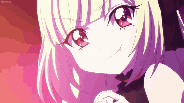 a girl with blonde hair and red eyes is smiling and looking at the camera