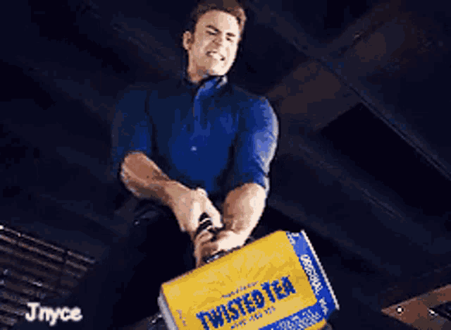 a man holding a can of twisted tea in his hands