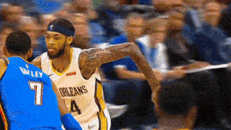 two basketball players are playing a game of basketball and one of them is wearing a jersey with the number 4 .