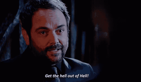a man with a beard is smiling and saying get the hell out of hell