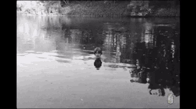 a black and white photo of a person in a body of water