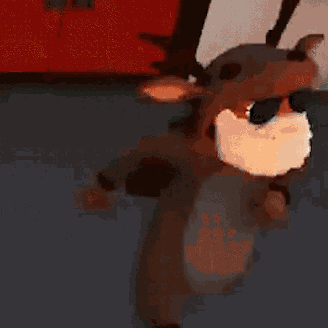a stuffed reindeer wearing sunglasses and a beard