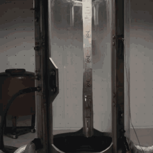 a stainless steel machine with a clear door has the letters oi on it