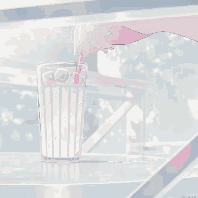 a hand is holding a pink straw over a glass of water