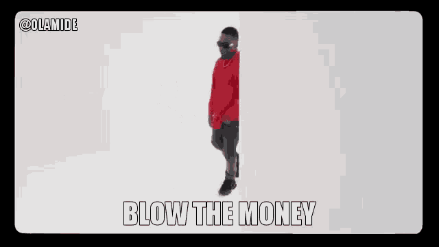 two men are dancing in front of a white wall with the words blow the money written on the screen .