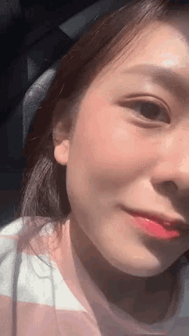a close up of a woman 's face with pink lipstick