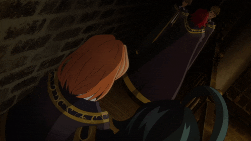 a group of people are standing in a dark room and one of them has red hair
