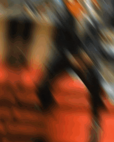 a blurry picture of a person 's face with orange and black lines