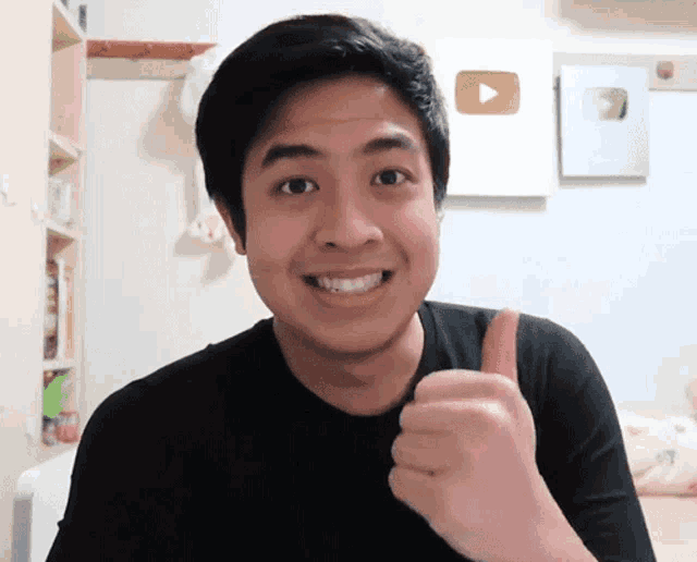 a man giving a thumbs up in front of a youtube icon