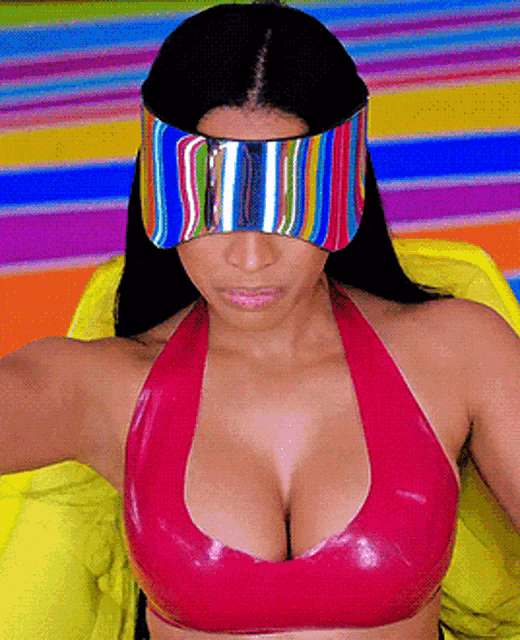 a woman wearing a red top and a colorful visor on her face