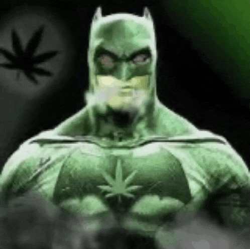 a man in a batman costume is smoking a cigarette .