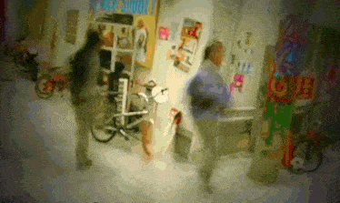 a blurry picture of people walking in a room with a sign that says love on it