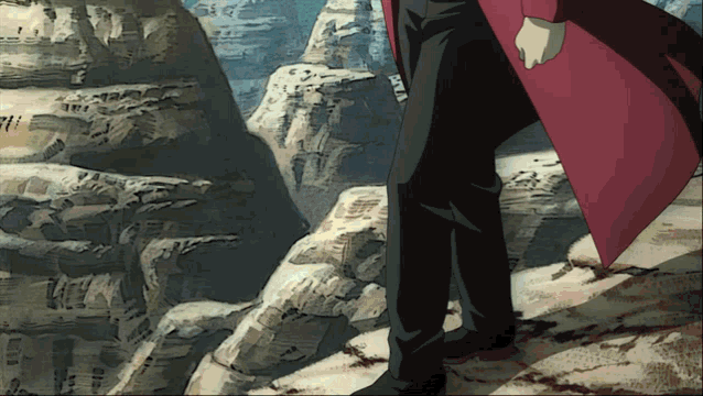 a man in a red coat is standing in front of a mountain