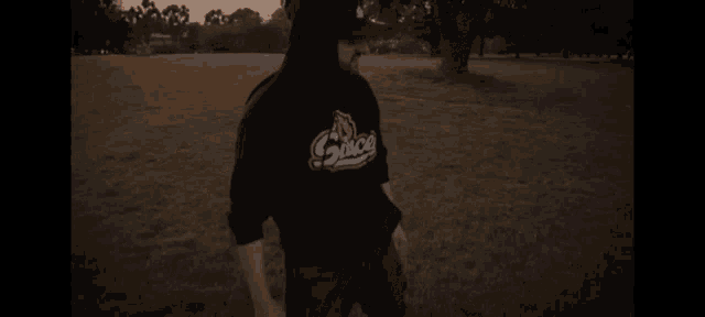 a man wearing a black hoodie that says sauce