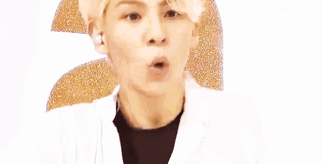 a young man is making a funny face with his mouth open and his tongue sticking out .
