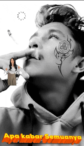 a man with a tattoo on his face is smoking a cigarette with a woman holding a shirt in the background