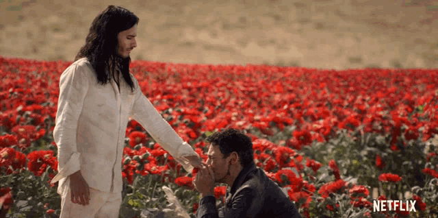 two men in a field of red flowers with netflix written in the corner
