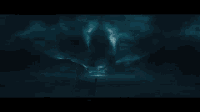 a man is standing in the dark with a lightning bolt behind him