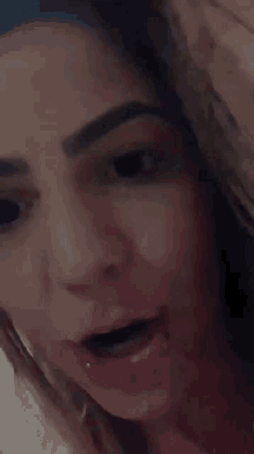 a close up of a woman 's face with a smile on her face .