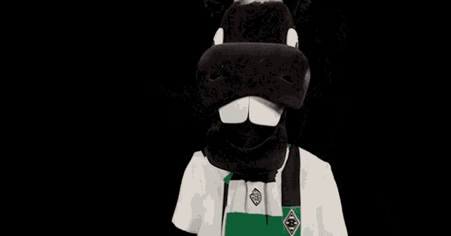 a black and white horse mascot wearing a white shirt