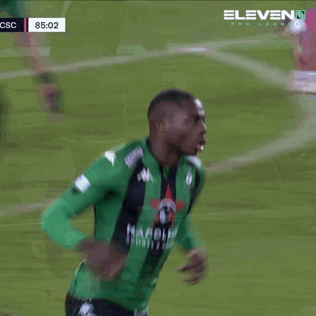 a soccer player wearing a green jersey that says napoleo sports & co.