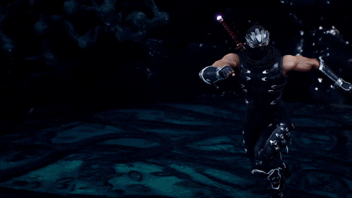 a man in a ninja costume is holding a light in his hand .