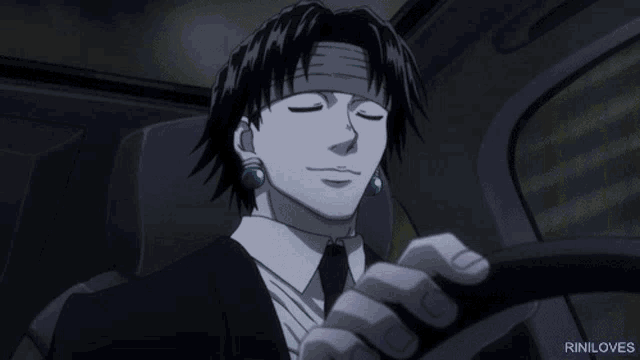 a man in a suit and tie is driving a car with riniloves written on the bottom right