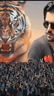 a man in sunglasses stands in front of a crowd of people with a tiger in the background