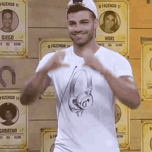 a man wearing a white shirt with headphones on it