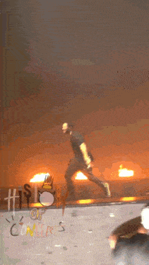 a man runs across a stage in front of a sign that says history of oncet