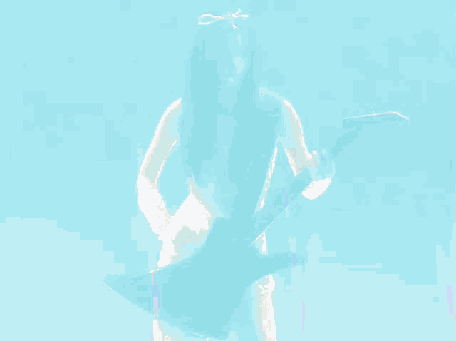 a woman playing a guitar in a dark room
