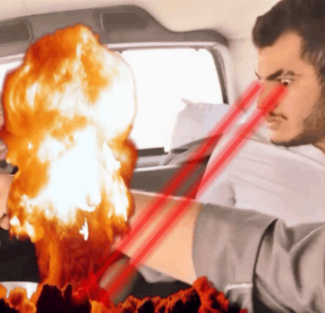 a man is sitting in a car with a red light coming out of his eye