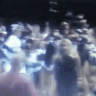 a blurry picture of a crowd of people in a room