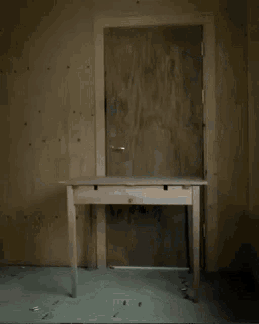 a white table in a dark room with a door open