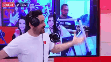 a man wearing headphones is dancing in front of a screen that says direct on it