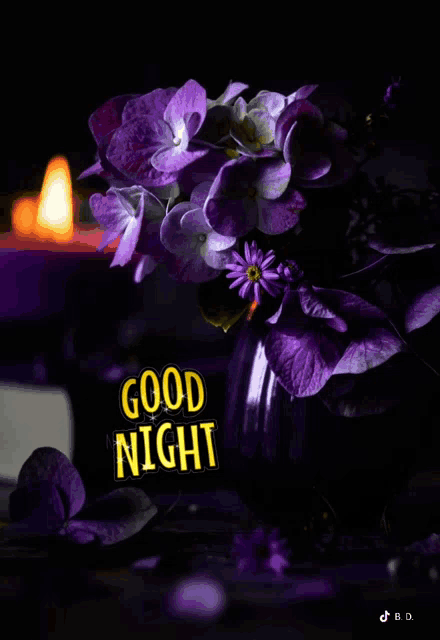 purple flowers in a vase with the words good night written on it