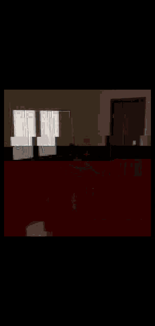 a person is sitting at a table in a living room