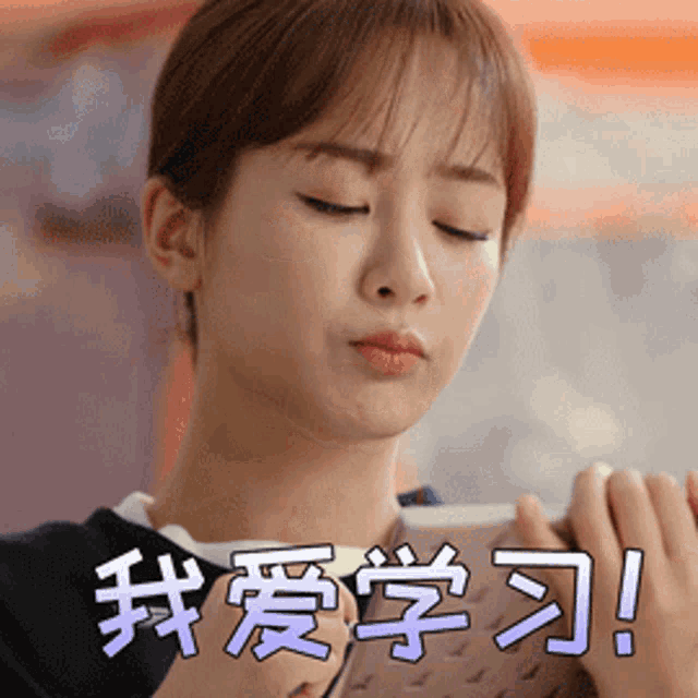 a woman is holding a book with chinese characters on it