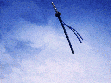 a sword is flying through a cloudy blue sky with the word samurai on the bottom