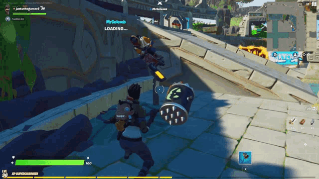 a man in a video game is standing next to a drum that says loading on it