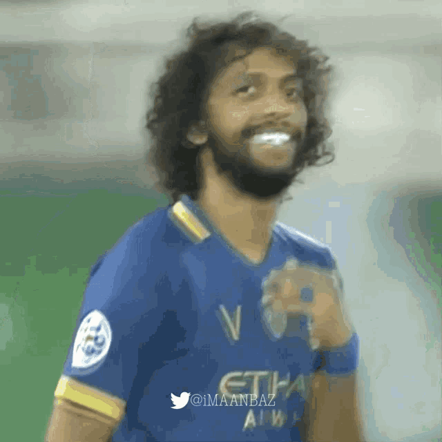 a man wearing a blue shirt that says etihad air