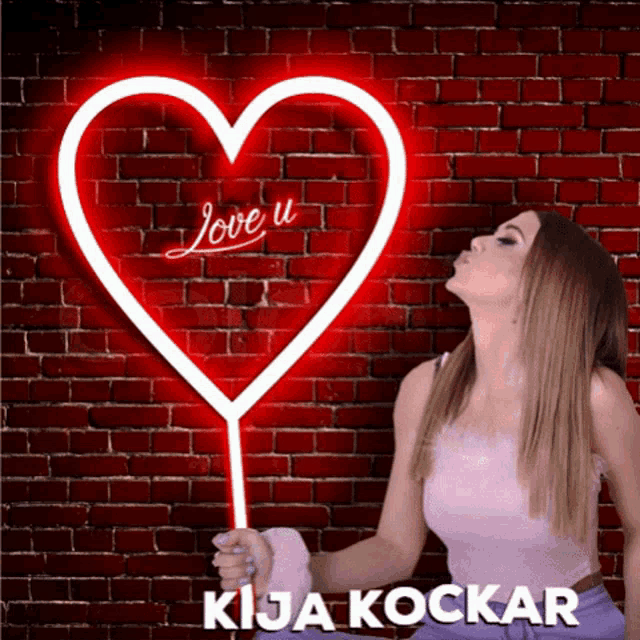 a woman is blowing a kiss in front of a neon heart that says love u