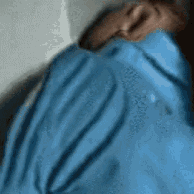 a person in a blue shirt is laying down
