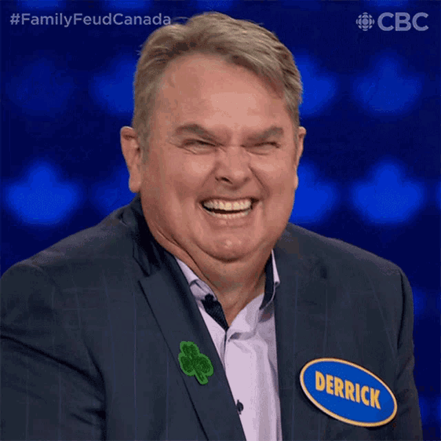 a man in a suit has a name tag that says derrick on it