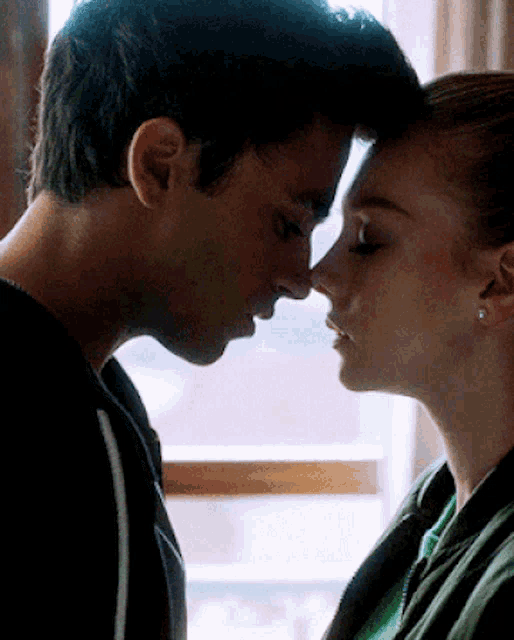 a man and a woman are looking into each others eyes