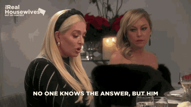two women are sitting at a table with the words no one knows the answer but him