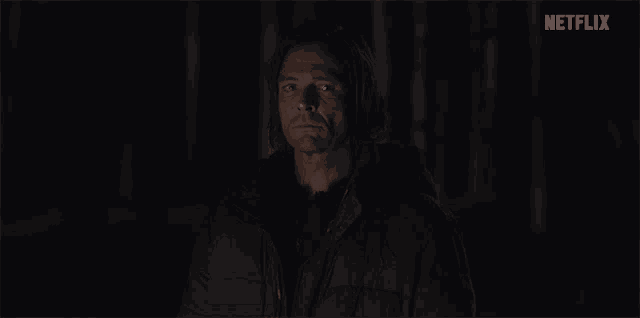 a man in a dark room with netflix written on the bottom